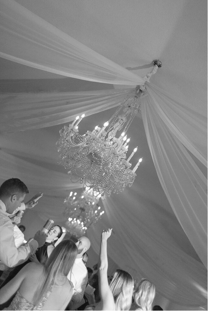 - 07 chandeliers drapped with fabric above wedding reception party 900x