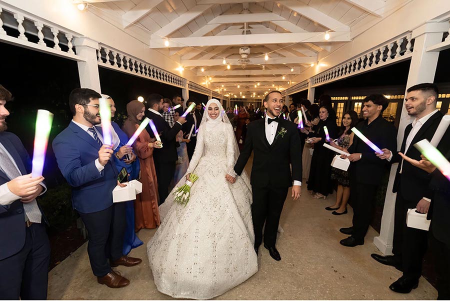 - 11 wedding couple leaving their reception surrounded by the wedding guests