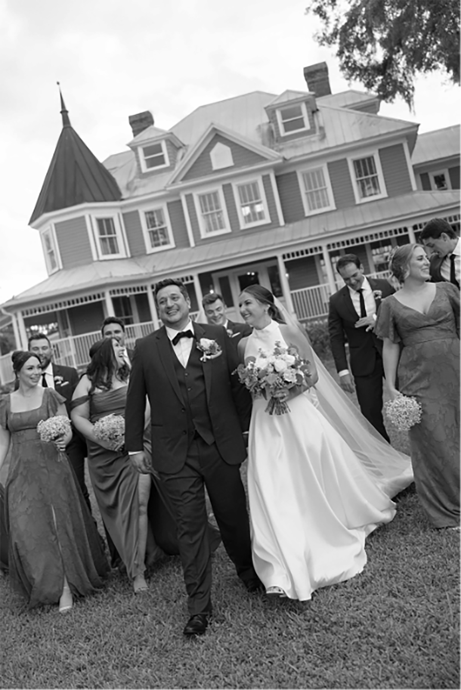 - 13 the entire wedding party walking toward the camera with the Highland Manor in the background