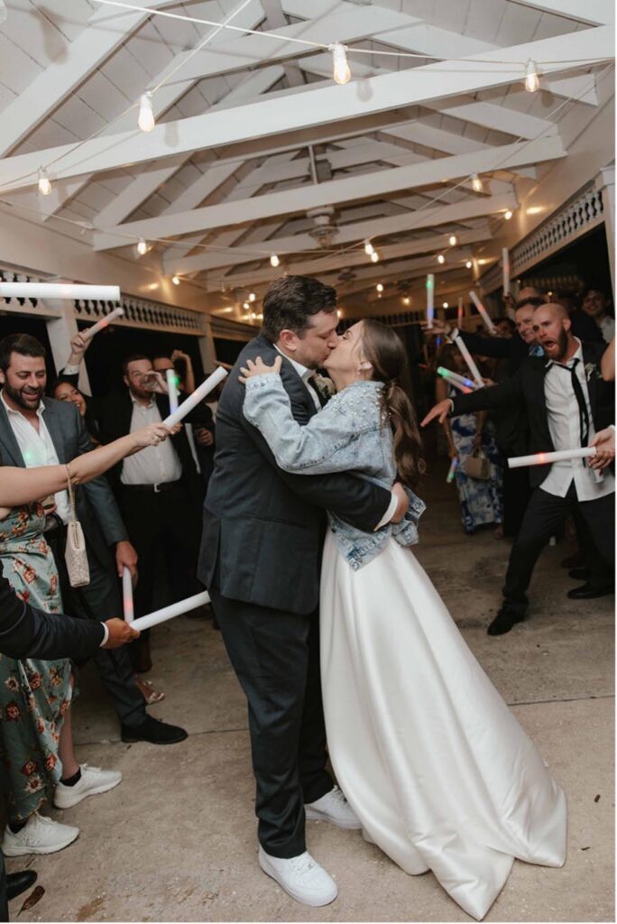 - 14 bride and groom kissing at the end of their reception line after their wedding 900x
