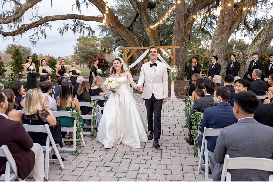 Emily and Jack walking down the aisle after their wedding at Historic Dubsdread Orlando