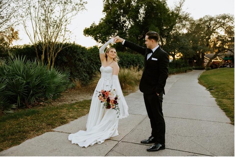 Bride and groom dancing on outdoor path