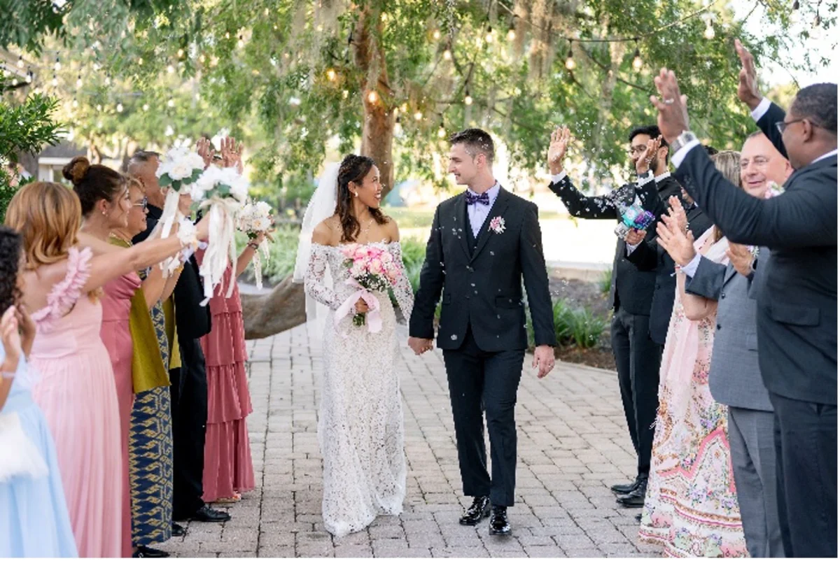Bride and groom walking through their receiving line