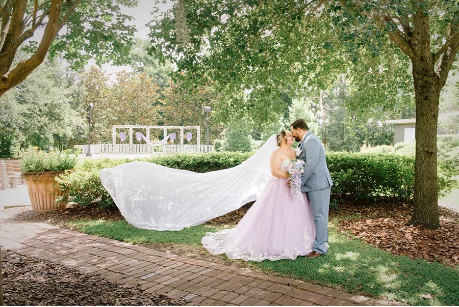 bride and groom posing in Winter Park garden