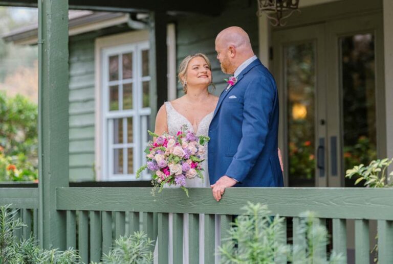 bride-and-groom-standing-on-porch-after-their-wedding-in-Orlando