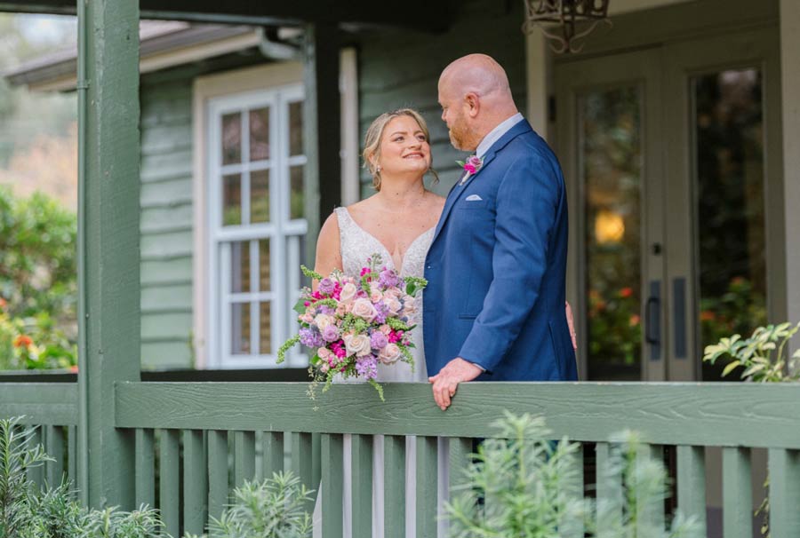 bride-and-groom-standing-on-porch-after-their-wedding-in-Orlando