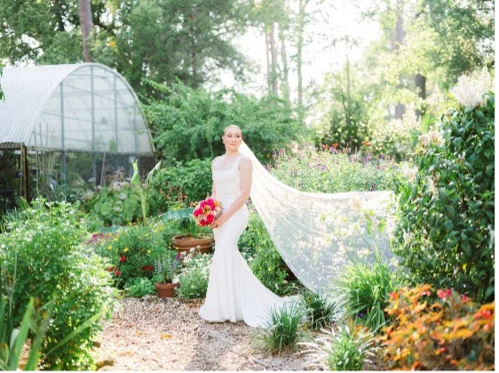 bride posing in the garden Azalea Lodge at Mead Botanical Garden, Anna So Photography