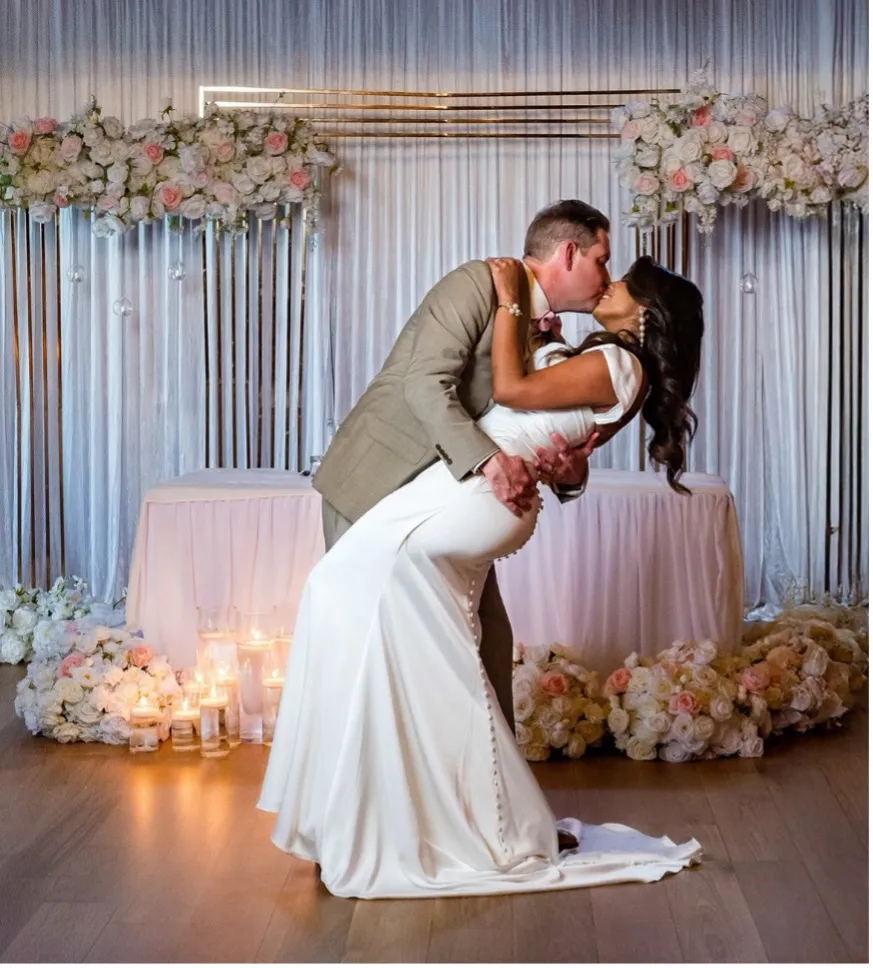 groom kissing the bride as he dips her