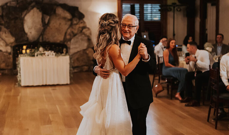 Father of bride dancing with his daughter, the bride.