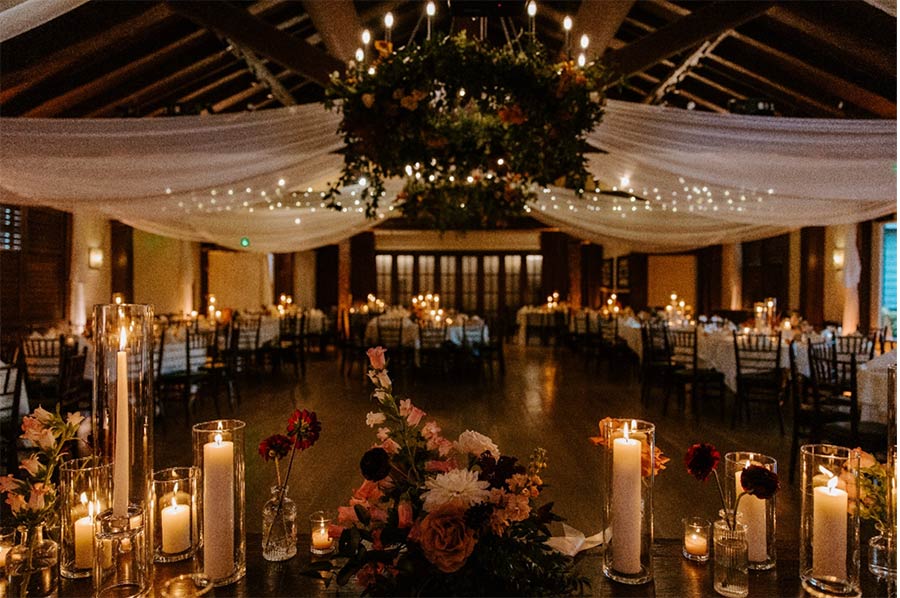 indoor-wedding-reception-hall-lit-up-by-candles