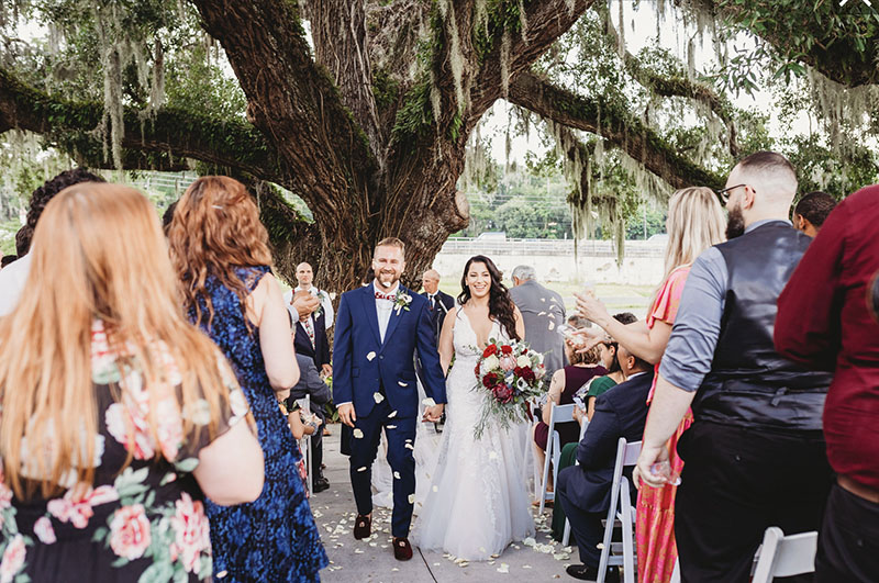newly married couple walking down the aisle together